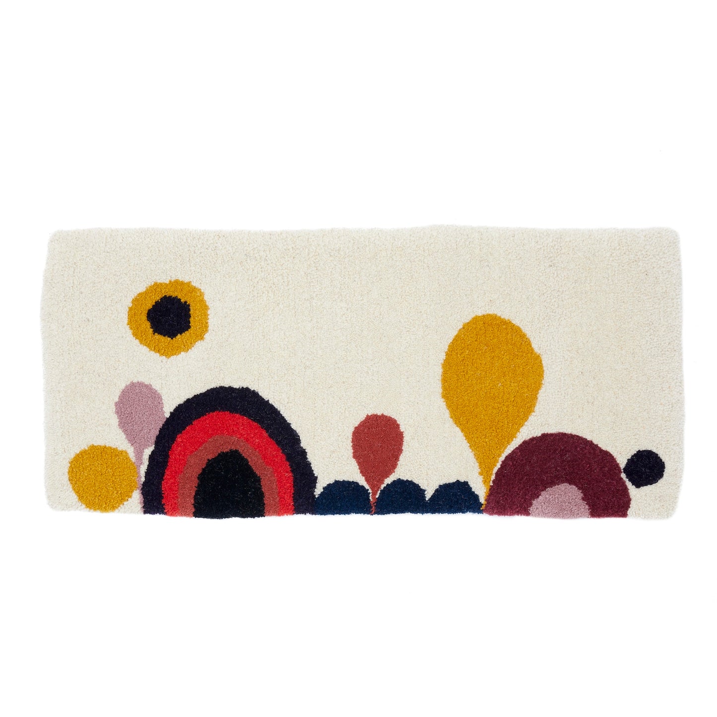 A cartoon-esque Candy Landscape rug runner with rainbows, hills and trees, hand tufted in a mixture of mustard, lilac, cream, red, coral, black, navy and maroon reclaimed yarns. A cut pile finish with hand bound mustard edges.