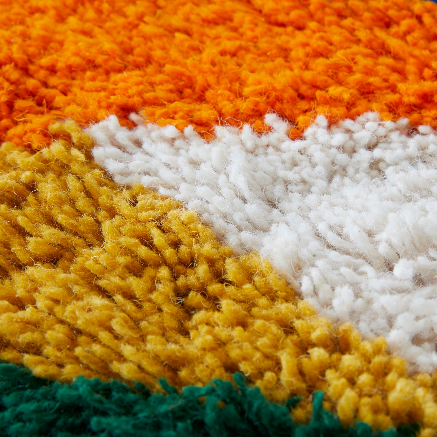 Large latch hook Wall Hanging, a beautiful balance of coloured triangles in orange, blue, cream, green, mustard and lilac reclaimed yarns close up.