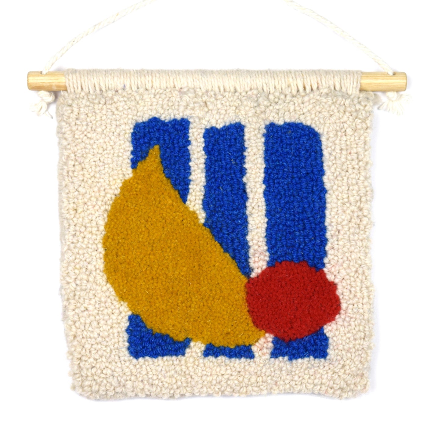 A Hand Tufted Wall Hanging in a loop and cut pile, using reclaimed yarn in mustard, red, blue and cream. Contemporary use of semi-circle, circle and stripes. 