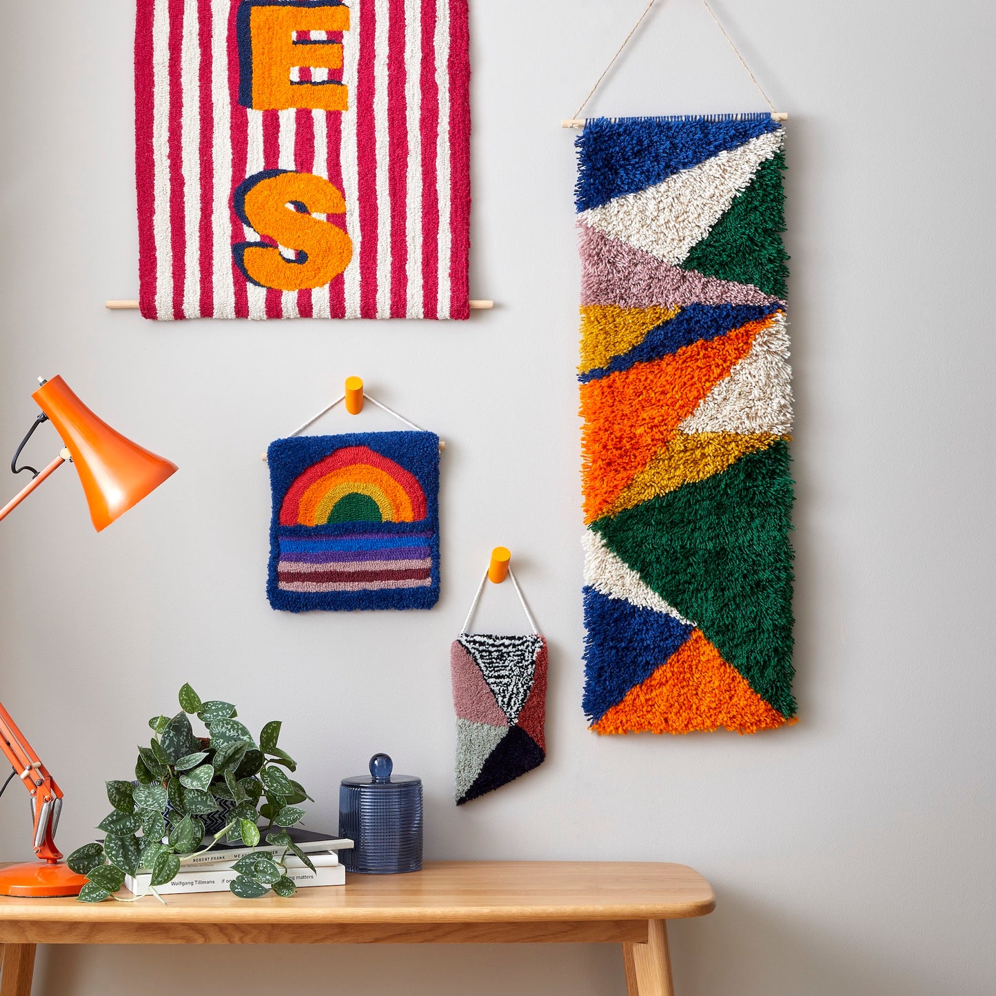 Large latch hook Wall Hanging, a beautiful balance of coloured triangles in orange, blue, cream, green, mustard and lilac reclaimed yarns group image.
